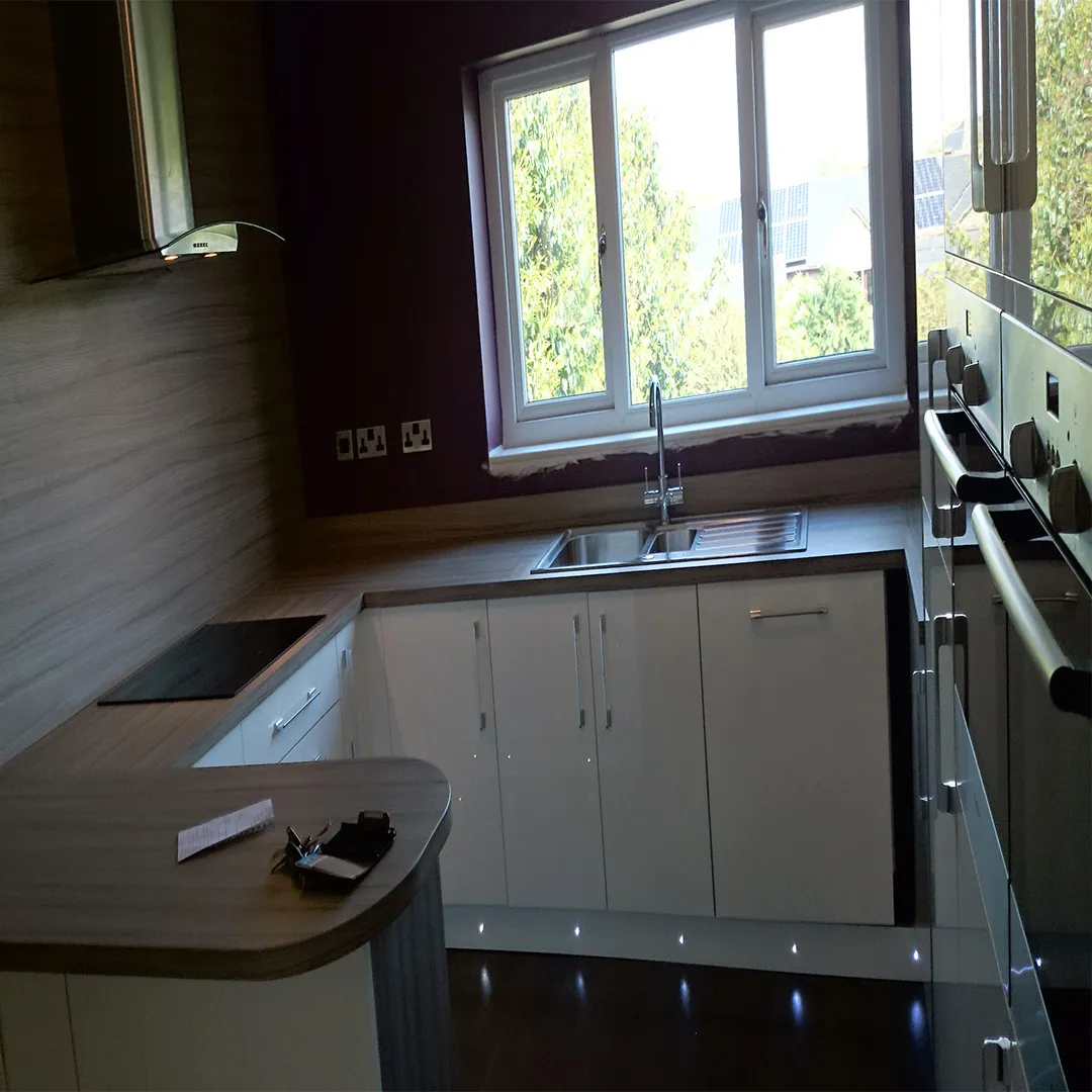 white gloss kitchen with laminate bench top led kickboard 